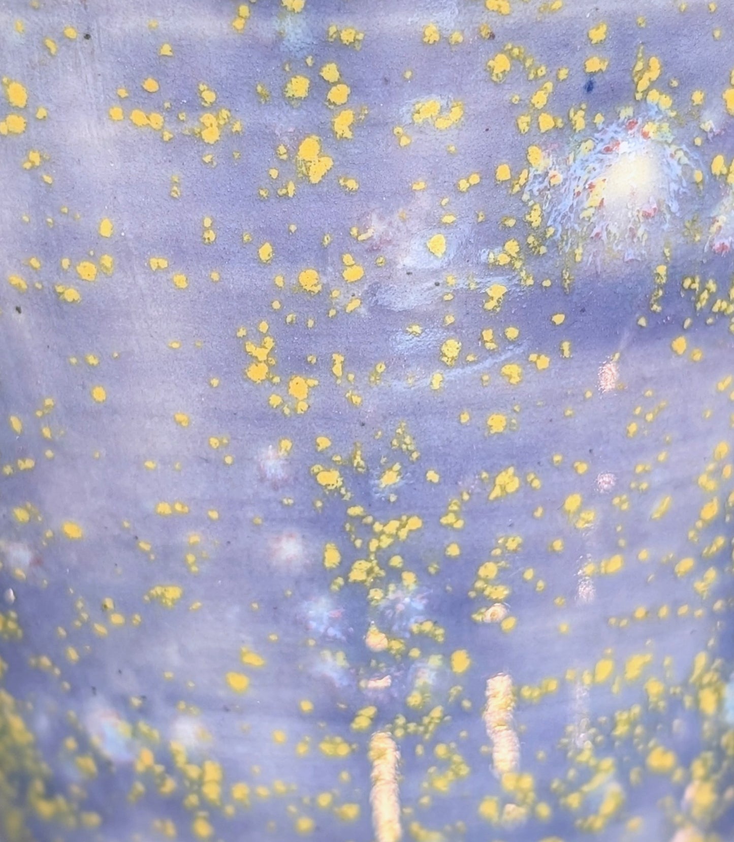 Abstract pattern with yellow specks on a light purple background